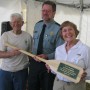 Russ (at left) and Katie Moncrief are given commemorative paddle by State Parks manager Warren Poplin (photo - CMF Public Media)