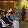 At podium, applicant Pam Carroll addresses city commission (photo - CMF Public Media)