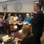Candidate Jeff Dowdy (standing at right) addresses luncheon audience (photo - CMF Public Media)